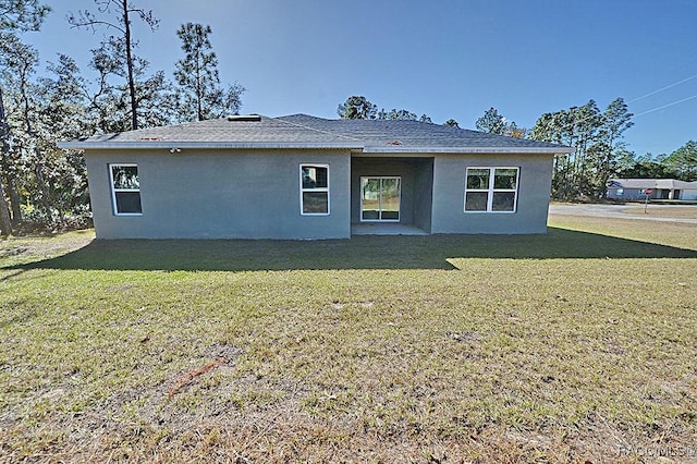 rear view of property with a patio area and a yard