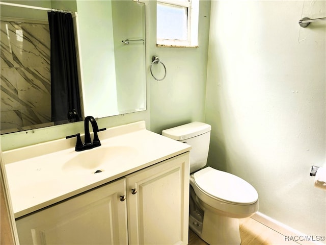 bathroom with a shower with shower curtain, vanity, toilet, and hardwood / wood-style floors