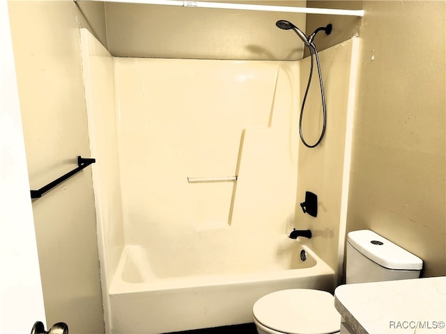 bathroom with bathing tub / shower combination and toilet