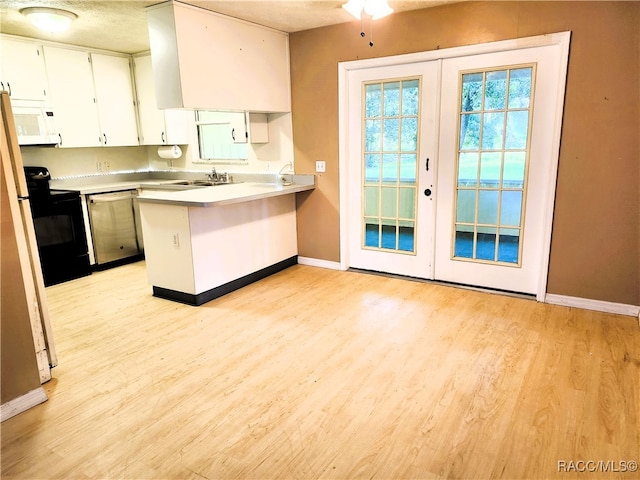 kitchen featuring french doors, black electric range oven, stainless steel dishwasher, kitchen peninsula, and white cabinets