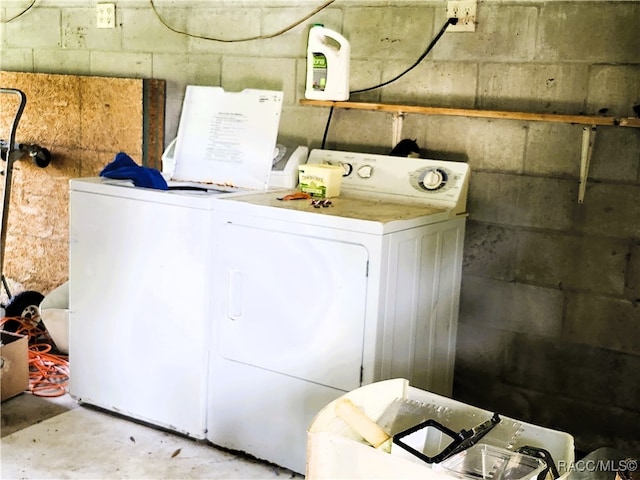 clothes washing area featuring separate washer and dryer