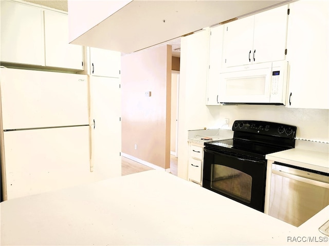 kitchen with white cabinets and white appliances