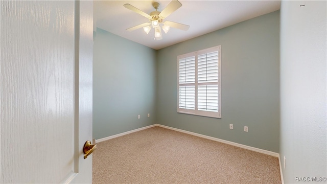 carpeted empty room featuring baseboards and ceiling fan