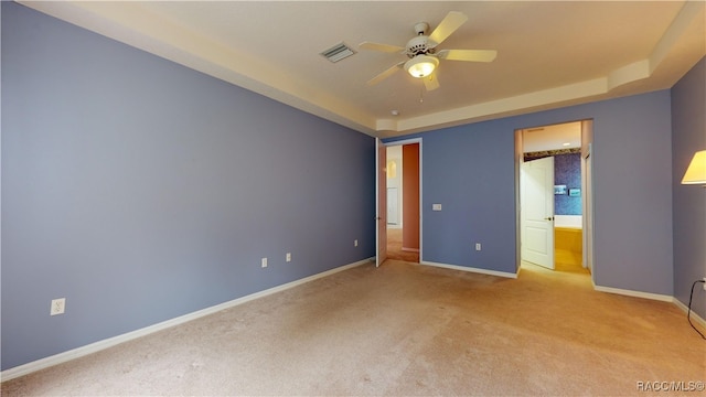 unfurnished bedroom featuring visible vents, ensuite bath, carpet, baseboards, and ceiling fan