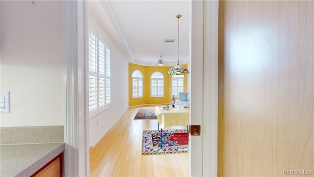 bathroom with visible vents, wood finished floors, a ceiling fan, and ornamental molding