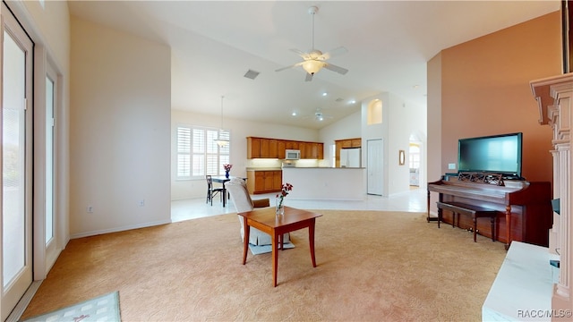 living room with visible vents, light carpet, high vaulted ceiling, a ceiling fan, and baseboards