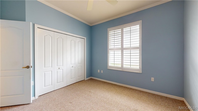 unfurnished bedroom featuring a closet, carpet flooring, baseboards, and ornamental molding