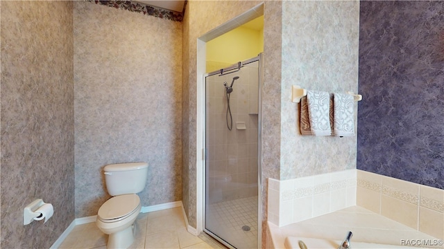 bathroom with wallpapered walls, toilet, a shower stall, and tile patterned flooring