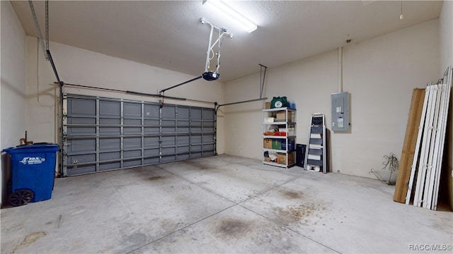 garage with electric panel and a garage door opener