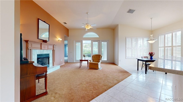 sitting room with a healthy amount of sunlight, visible vents, and a premium fireplace