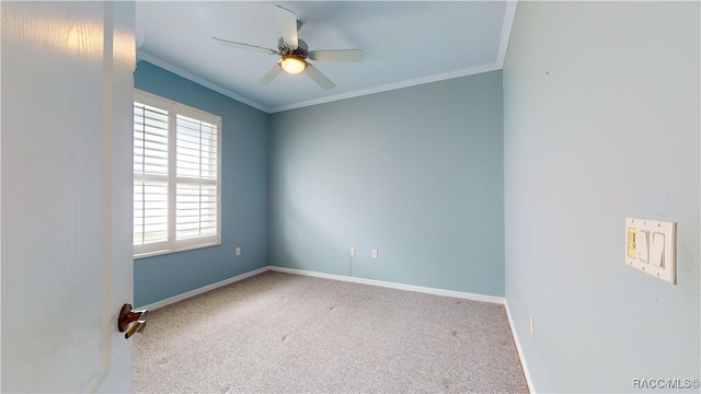 carpeted empty room with baseboards, crown molding, and ceiling fan