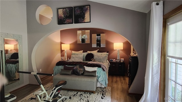 bedroom featuring wood-type flooring and lofted ceiling