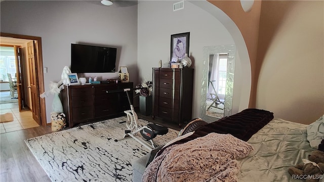 bedroom with light hardwood / wood-style floors and multiple windows