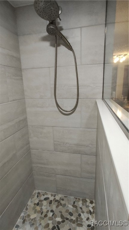 bathroom with tiled shower