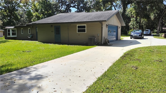 view of front facade with central air condition unit, a front yard, and a garage