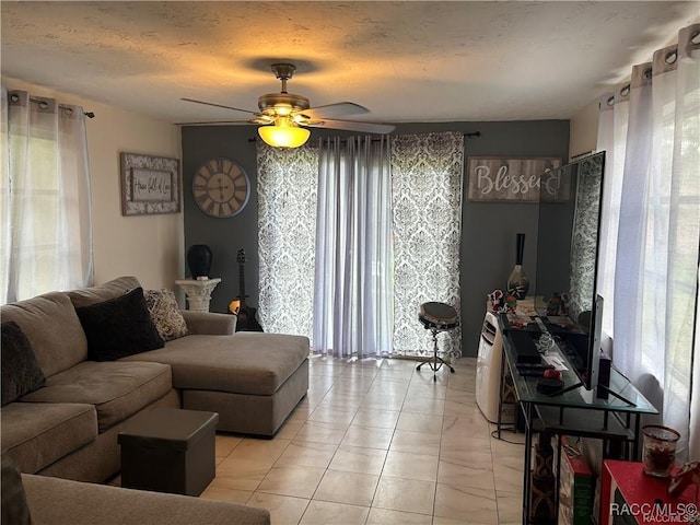 living room with a textured ceiling and a ceiling fan