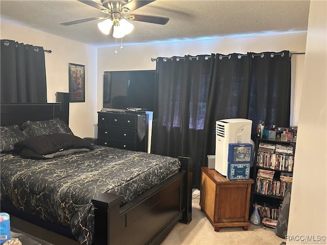 bedroom with carpet floors, a ceiling fan, and a textured ceiling