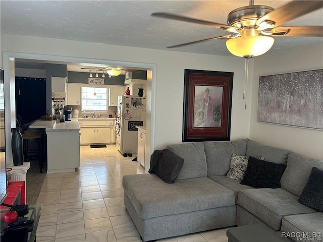 living room featuring a textured ceiling and a ceiling fan