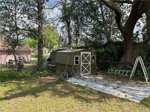 view of shed featuring fence