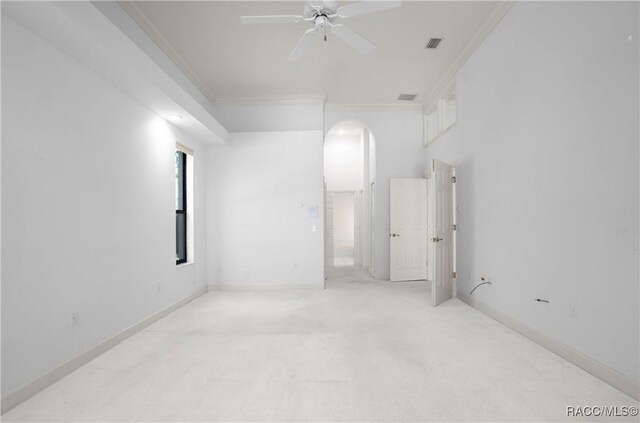 5550 W Yearling Dr, Beverly Hills, FL 34465 - unfurnished room featuring ornamental molding, arched walkways, a ceiling fan, and carpet floors
