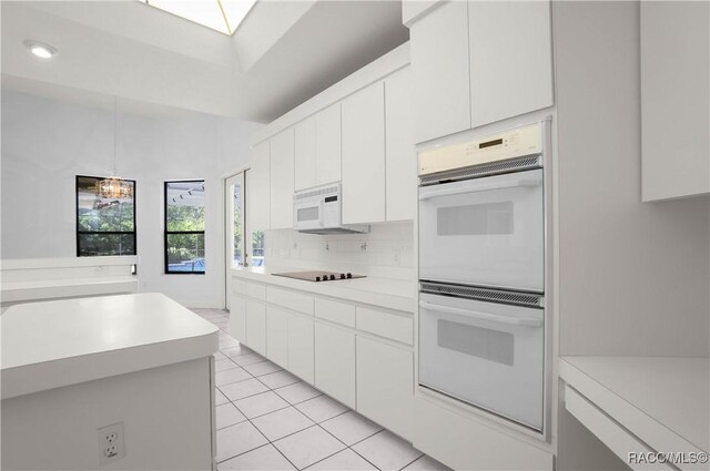 5550 W Yearling Dr, Beverly Hills, FL 34465 - kitchen with white appliances, light countertops, decorative backsplash, pendant lighting, and white cabinetry