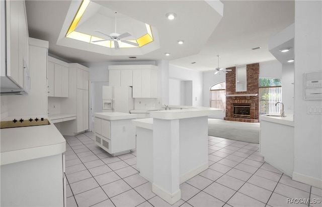 5550 W Yearling Dr, Beverly Hills, FL 34465 - kitchen featuring ceiling fan, white fridge with ice dispenser, a fireplace, and black electric stovetop
