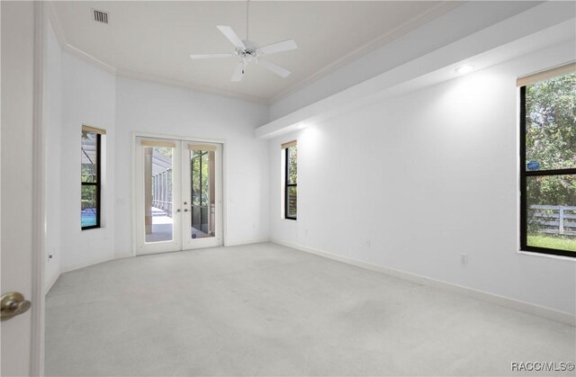 5550 W Yearling Dr, Beverly Hills, FL 34465 - empty room with french doors, light carpet, crown molding, and a ceiling fan