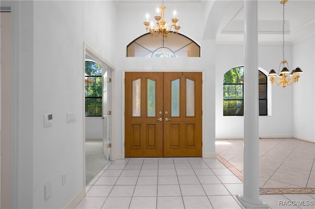 5550 W Yearling Dr, Beverly Hills, FL 34465 - foyer entrance with a chandelier, plenty of natural light, light tile patterned flooring, a towering ceiling, and crown molding