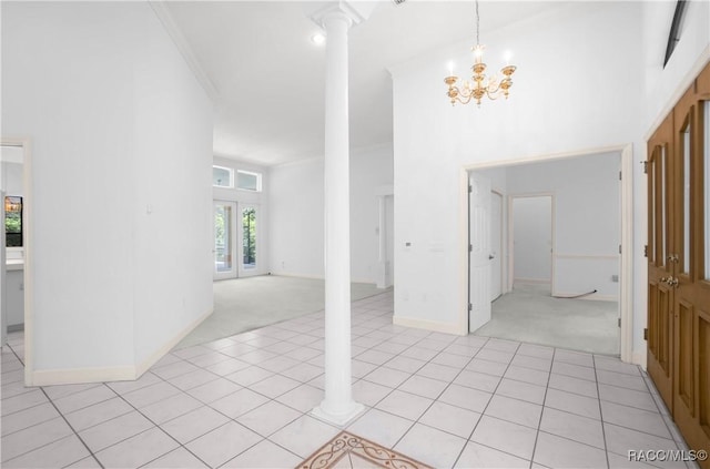 5550 W Yearling Dr, Beverly Hills, FL 34465 - entrance foyer with light colored carpet, decorative columns, light tile patterned floors, a chandelier, and a high ceiling