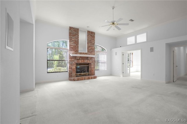 5550 W Yearling Dr, Beverly Hills, FL 34465 - unfurnished living room with a ceiling fan, a brick fireplace, plenty of natural light, carpet flooring, and a high ceiling