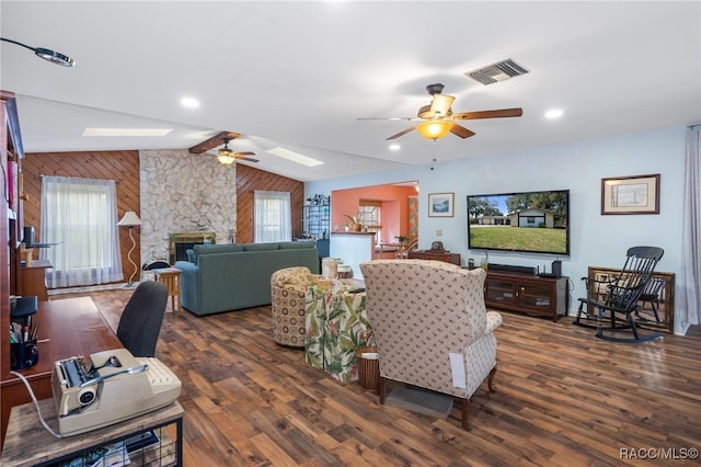 living room with dark hardwood / wood-style floors, lofted ceiling with beams, and a wealth of natural light