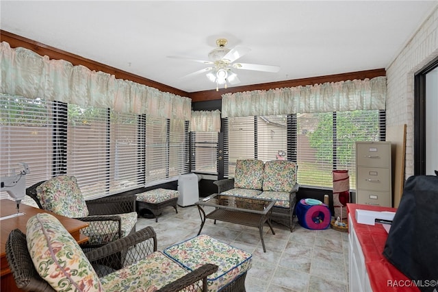 interior space with ceiling fan and ornamental molding