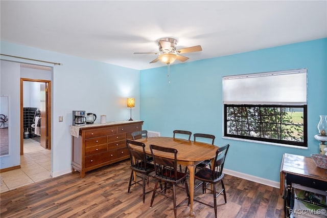 dining room featuring dark hardwood / wood-style floors and ceiling fan