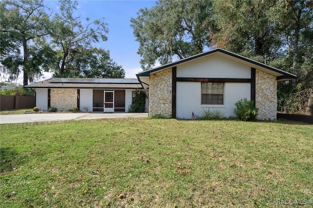 927 Cedar Ave, Inverness, FL 34452 - mid-century inspired home featuring stone siding, solar panels, a sunroom, and stucco siding