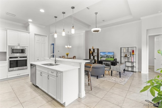 kitchen featuring white cabinets, sink, a kitchen island with sink, and appliances with stainless steel finishes