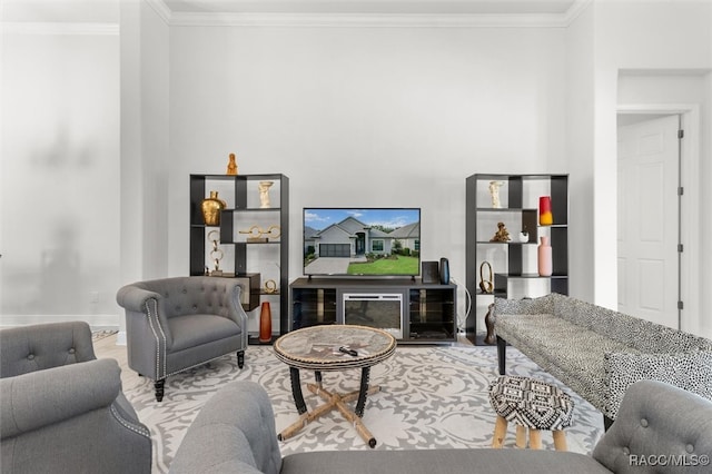 living room featuring a fireplace, hardwood / wood-style flooring, and crown molding