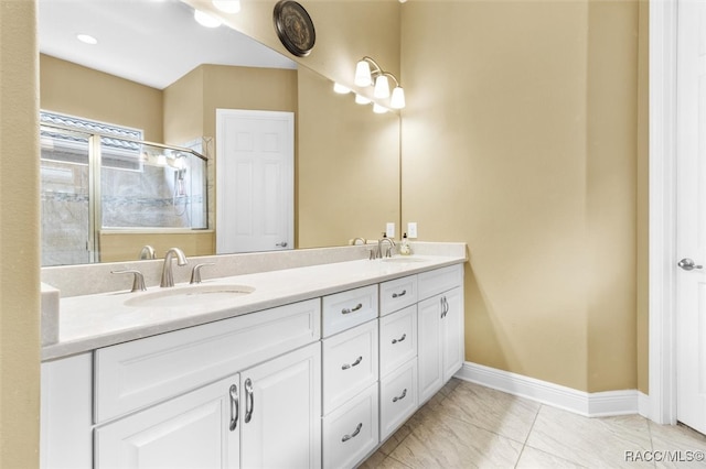 bathroom with tile patterned flooring, vanity, and walk in shower