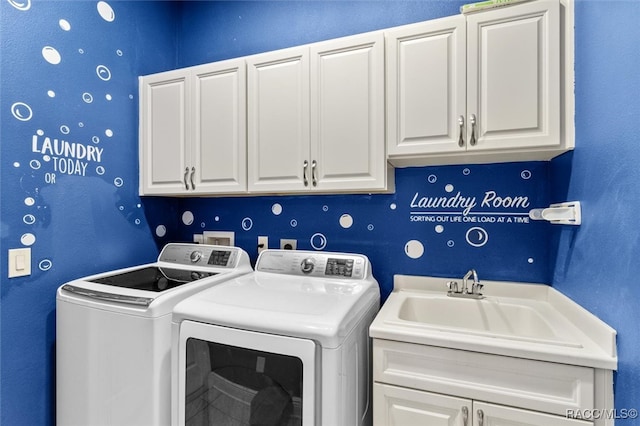 laundry room with cabinets, separate washer and dryer, and sink