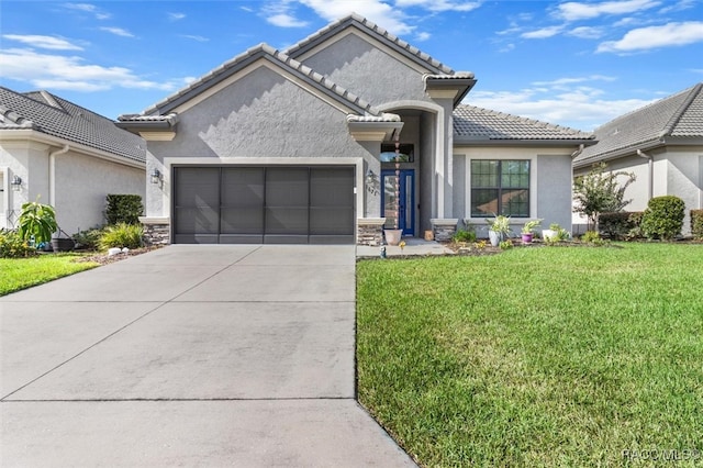 view of front of property featuring a garage and a front lawn