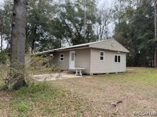 rear view of property with a lawn