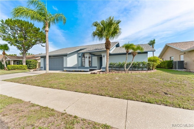 8638 Chadwick Dr, Tampa, FL 33635 - view of front of house featuring an attached garage, driveway, stucco siding, and a front lawn