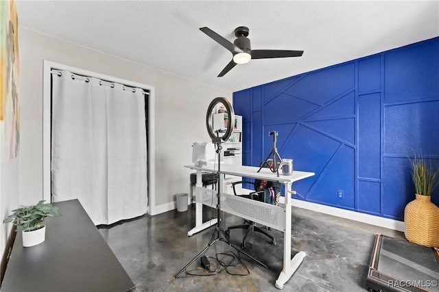 8638 Chadwick Dr, Tampa, FL 33635 - home office featuring a decorative wall, concrete flooring, ceiling fan, and baseboards