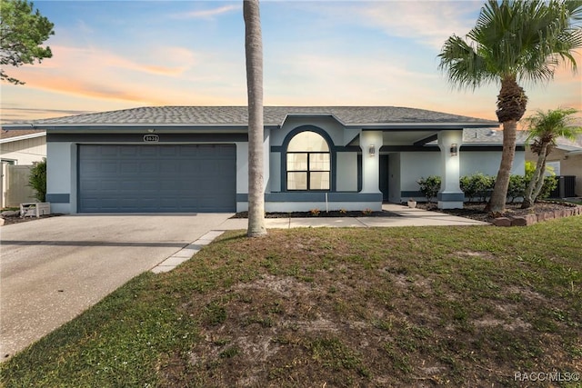8638 Chadwick Dr, Tampa, FL 33635 - ranch-style house featuring stucco siding, an attached garage, driveway, roof with shingles, and a front lawn
