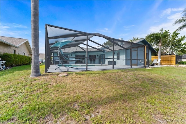 8638 Chadwick Dr, Tampa, FL 33635 - rear view of house with an outdoor pool, a lawn, a lanai, and a patio