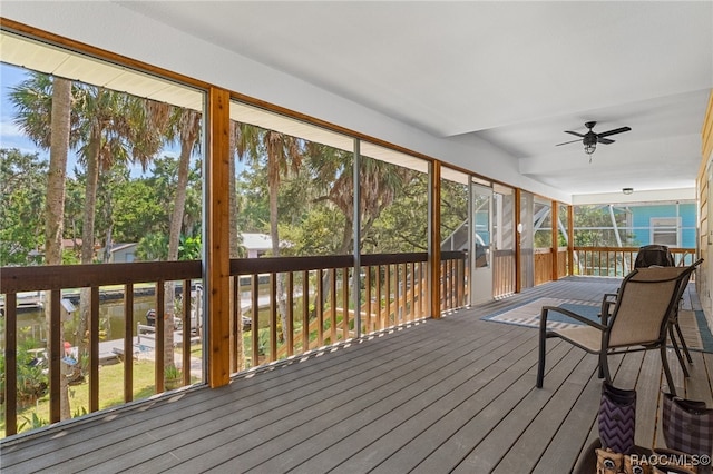 sunroom / solarium featuring ceiling fan