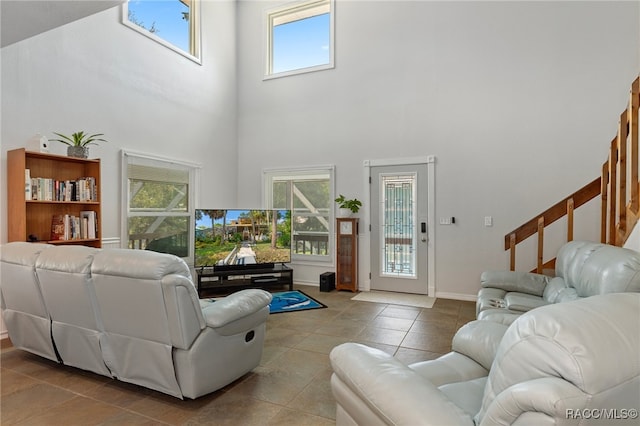 living room featuring light tile patterned floors and a high ceiling