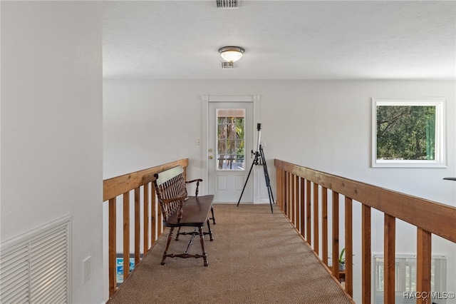 hallway featuring light colored carpet