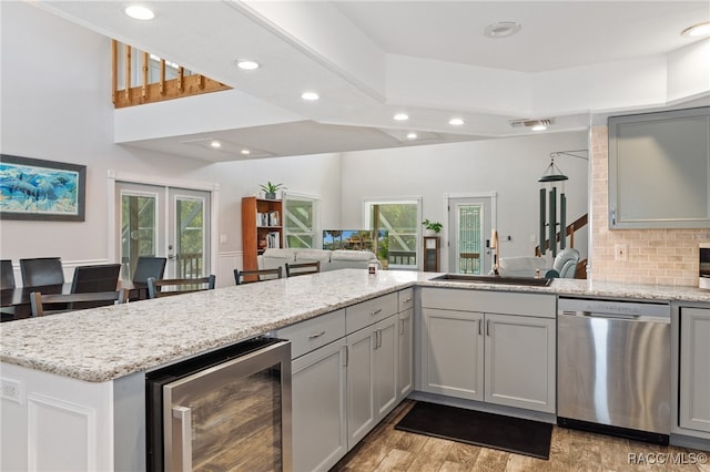 kitchen with wine cooler, stainless steel dishwasher, plenty of natural light, and sink