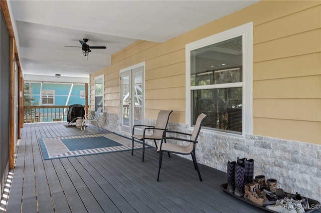 wooden deck featuring ceiling fan