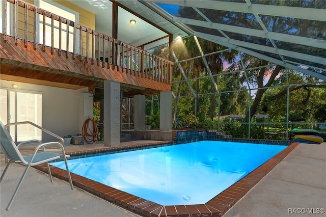 view of pool featuring a patio and glass enclosure